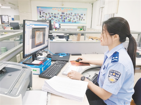 車管所網(wǎng)辦中心工作人員在對用戶提交的資料進行審核。